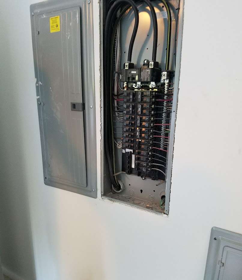 A newly installed residential electrical circuit breaker panel with neatly organized wiring, replacing an outdated system.