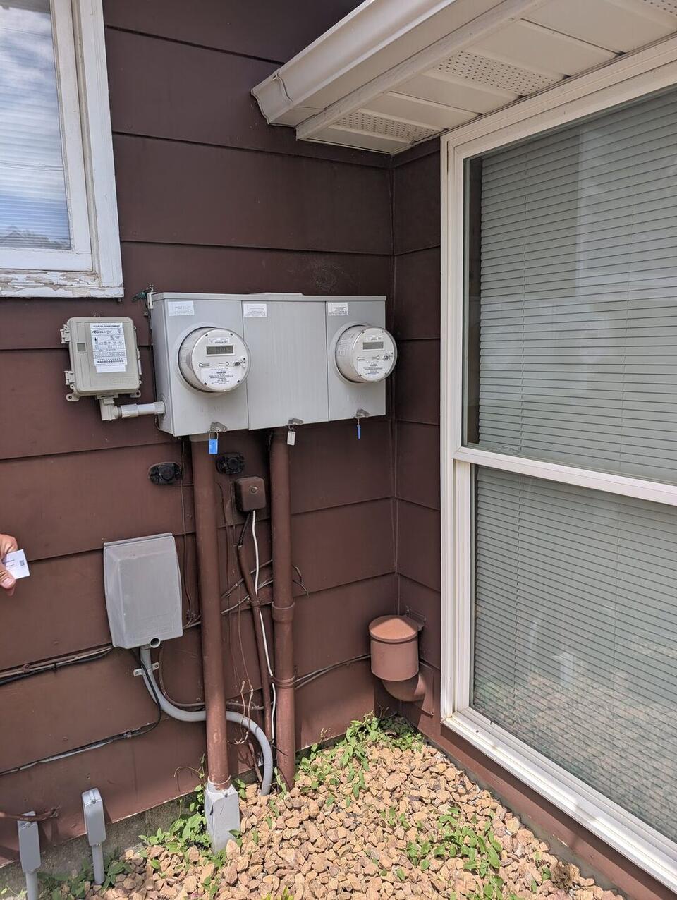 Exterior dual electric meter base and utility load control receiver before EV charger installation in Canby MN