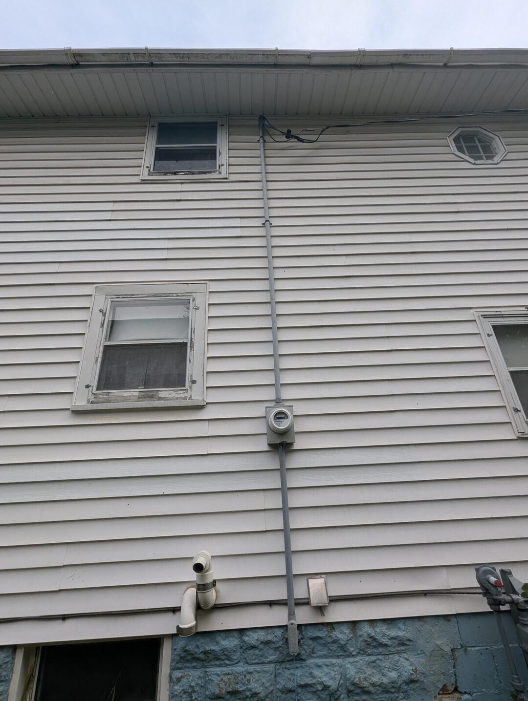 Before: Service mast between operable windows