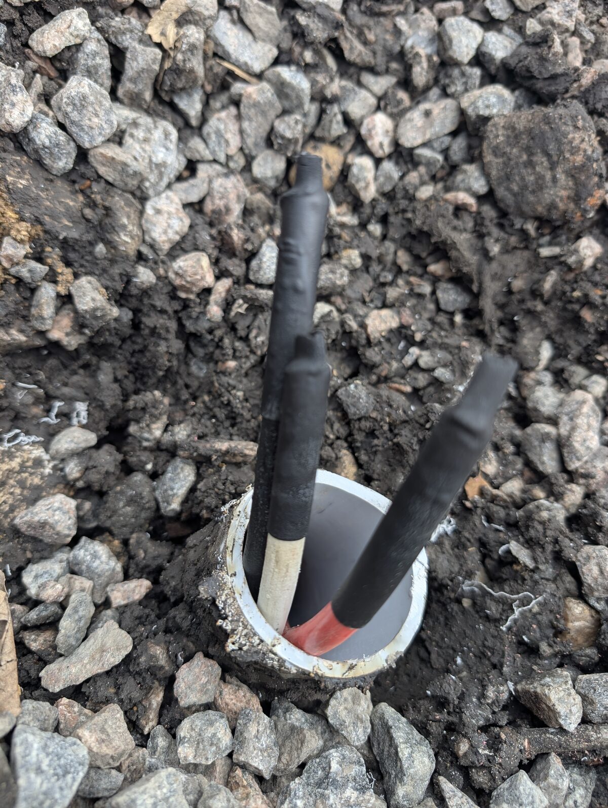 Service entrance conductors insulated with heat-shrink tubing inside PVC conduit stub