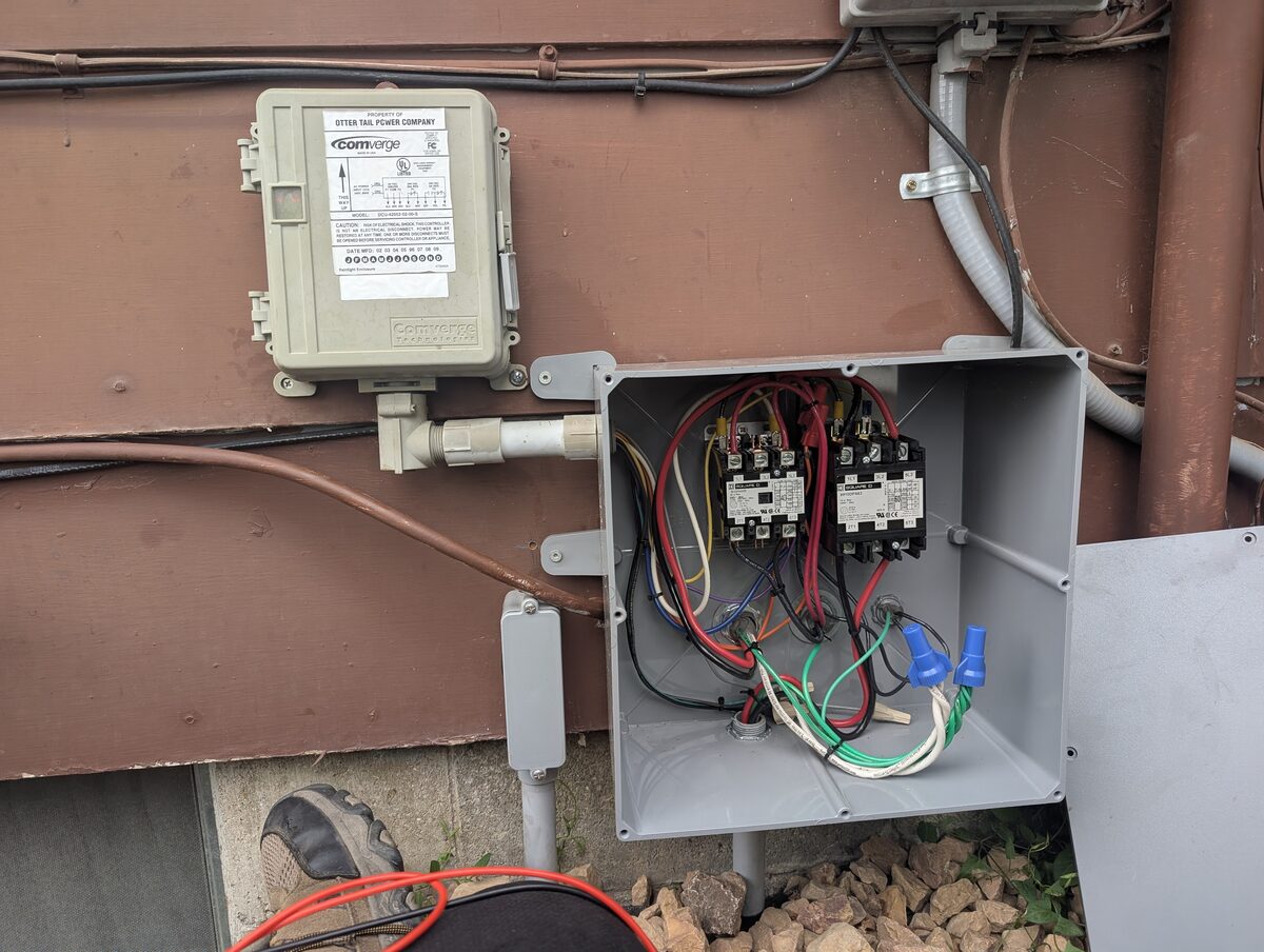 Completed outdoor NEMA 3R load control enclosure wired to Comverge utility receiver